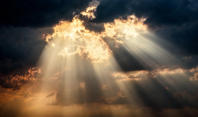 Sunlight through clouds symbolizing Jesus as the propitiation for our sins